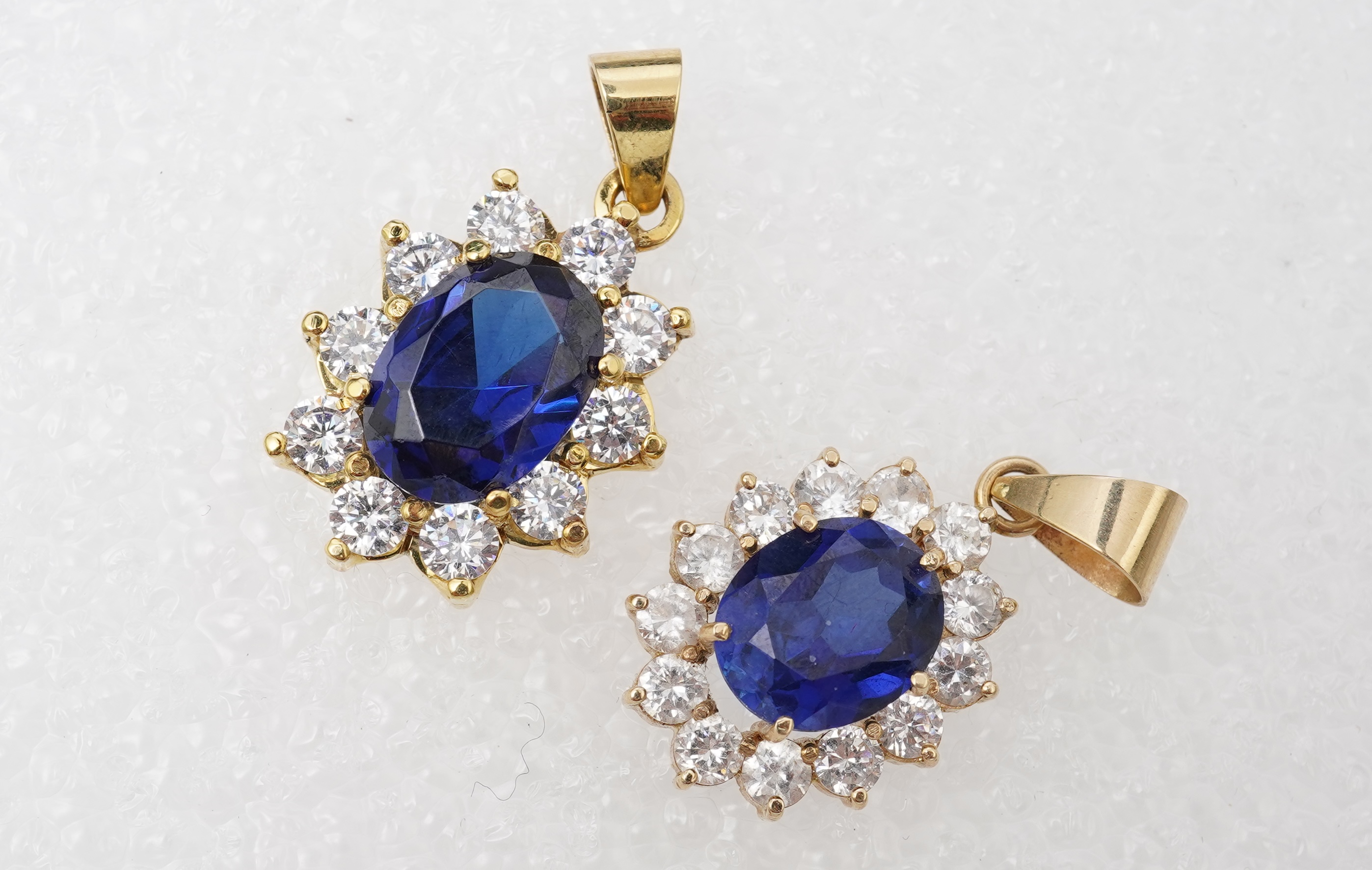 A synthetic sapphire and cubic zirconia necklace and two pendants, the necklace set with oval synthetic sapphires and brilliant-cut and marquise-shaped cubic zirconias, mounted in silver, length 44cm, stamped 925; togeth